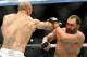 Johny Hendricks blocks a punch from Robbie Lawler during a UFC 171 mixed martial arts welterweight title bout, Saturday, March 15, 2014, in Dallas. Hendricks won by decision. (AP Photo/Matt Strasen)