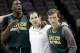 Baylor's Taurean Prince, left, coach Scott Drew, center, and Brady Heslip wait for the rest of the team to join them at center court during practice for the NCAA college basketball tournament in San Antonio, Thursday, March 20, 2014. Baylor plays against Nebraska in a second-round game on Friday. (AP Photo/David J. Phillip)