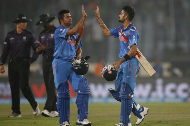 India's batsmen Suresh Raina, second right, and Virat Kohli, right, celebrate their victory over Pakistan in the ICC Twenty20 Cricket World Cup match in Dhaka, Bangladesh, Friday, March 21, 2014. (AP Photo/Aijaz Rahi)
