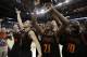 Mercer guard Langston Hall (21) and other Mercer players celebrate after the second half of an NCAA college basketball second-round game against Duke, Friday, March 21, 2014, in Raleigh, N.C. Mercer won 78-71. (AP Photo/Chuck Burton)