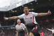 Liverpool's Luis Suarez celebrates after scoring against Manchester United, during their English Premier League soccer match at Old Trafford Stadium, Manchester, England, Sunday, March 16, 2014. (AP Photo/Jon Super)