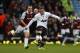 Manchester United's Wayne Rooney, right, scores from 45 yards out against West Ham United during their English Premier League soccer match at Upton Park, London, Saturday, March 22, 2014. (AP Photo/Sang Tan)