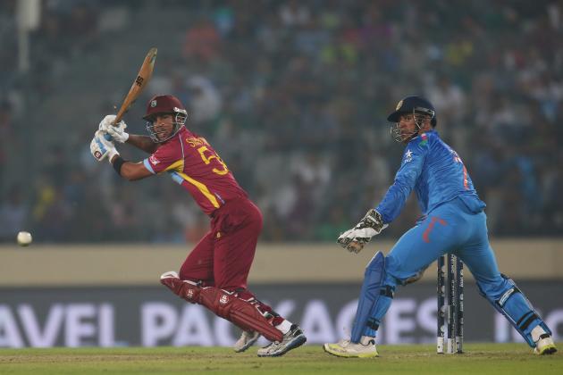 DHAKA, BANGLADESH - MARCH 23:  Lendl Simmons of the West Indies bats as MS Dhoni of India looks on during the ICC World Twenty20 Bangladesh 2014 match between the West Indies and India at Sher-e-Bangla Mirpur Stadium on March 23, 2014 in Dhaka, Bangladesh.  (Photo by Scott Barbour/Getty Images)