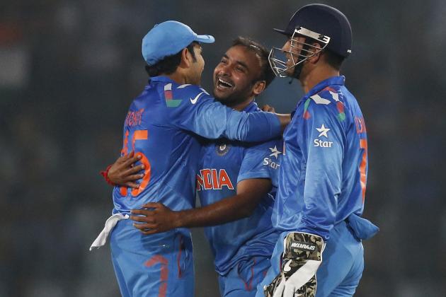 India's bowler Amit Mishra, center, celebrates with captain Mahendra Singh Dhoni, right, and teammate Rohit Sharma after taking the wicket of West Indies' batsman Dwayne Bravo during their ICC Twenty20 Cricket World Cup match in Dhaka, Bangladesh, Sunday, March 23, 2014. (AP Photo/Aijaz Rahi)