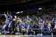 Kentucky players jump off the bench after winning a third-round game against Wichita State at the NCAA college basketball tournament Sunday, March 23, 2014, in St. Louis. Kentucky won the game 78-76. (AP Photo/Charlie Riedel)