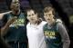 Baylor's Taurean Prince, left, coach Scott Drew, center, and Brady Heslip wait for the rest of the team to join them at center court during practice for the NCAA college basketball tournament in San Antonio, Thursday, March 20, 2014. Baylor plays against Nebraska in a second-round game on Friday. (AP Photo/David J. Phillip)
