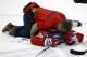 Washington Capitals trainer Greg Smith tends to defenseman Jack Hillen, after Hillen's collision with right wing Alex Ovechkin (8), from Russia, in the overtime portion of an NHL hockey game against the Los Angeles Kings, Tuesday, March 25, 2014, in Washington. The Kings won 5-4 in a shootout. (AP Photo/Alex Brandon)
