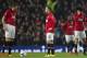 Manchester United players including Marouane Fellaini, right, Wayne Rooney, centre and Michael Carrick wait for play to restart after an early goal by Manchester City's Edin Dzeko, out of frame, during their English Premier League soccer match at Old Trafford Stadium, Manchester, England, Tuesday March 25, 2014. (AP Photo/Jon Super)