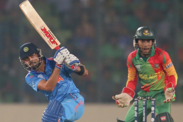 DHAKA, BANGLADESH - MARCH 28:  Virat Kohli of India bats as Mushfiqur Rahim of Bangladesh looks on during the ICC World Twenty20 Bangladesh 2014 match between Bangladesh and India at Sher-e-Bangla Mirpur Stadium on March 28, 2014 in Dhaka, Bangladesh.  (Photo by Scott Barbour/Getty Images)