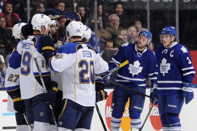 TORONTO, ON - MARCH 25: David Backes #42 of the St. Louis Blues celebrates a third period goal as Cody Franson #4 and Dion Phaneuf #3 of the Toronto Maple Leafs look on during NHL game action March 25, 2014 at the Air Canada Centre in Toronto, Ontario, Canada. (Photo by Graig Abel/NHLI via Getty Images)