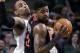 Toronto Raptors forward Amir Johnson (15) looks to pass against the defense of Boston Celtics center Jared Sullinger in the second half of an NBA basketball game in Boston, Wednesday, March 26, 2014. (AP Photo/Elise Amendola)