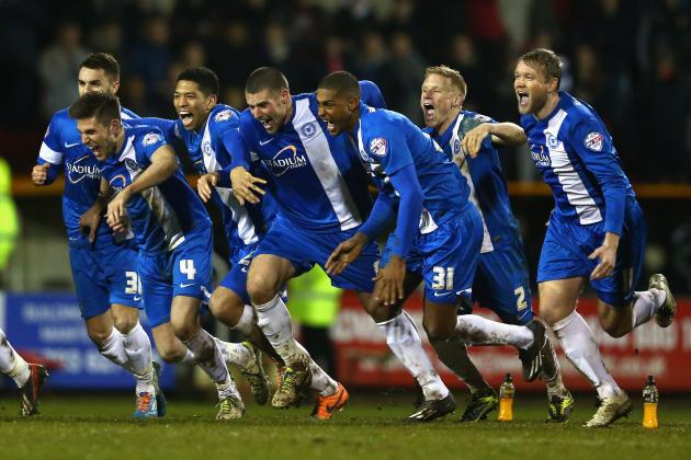 SWINDON, ENGLAND - FEBRUARY 17: The Peterborough United players celebrate their 4-3 win on penalties after Tommy Rowe converted the winning penalty during the Johnstone's Paint Southern Area Final Second Leg match between Swindon Town and Peterborough United at the County Ground on February 17, 2014 in Swindon, England.  (Photo by Michael Steele/Getty Images)