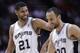 San Antonio Spurs' Tim Duncan (21) celebrates with Manu Ginobili (20) during the second half of an NBA basketball game against the Denver Nuggets, Wednesday, March 26, 2014, in San Antonio. San Antonio won 108-103. (AP Photo/Eric Gay)
