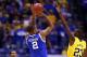 INDIANAPOLIS, IN - MARCH 30: Aaron Harrison #2 of the Kentucky Wildcats shoots the game winning shot late against Caris LeVert #23 of the Michigan Wolverines during the midwest regional final of the 2014 NCAA Men's Basketball Tournament at Lucas Oil Stadium on March 30, 2014 in Indianapolis, Indiana. The Kentucky Wildcats defeated the Michigan Wolverines 75 to 72. (Photo by Andy Lyons/Getty Images)