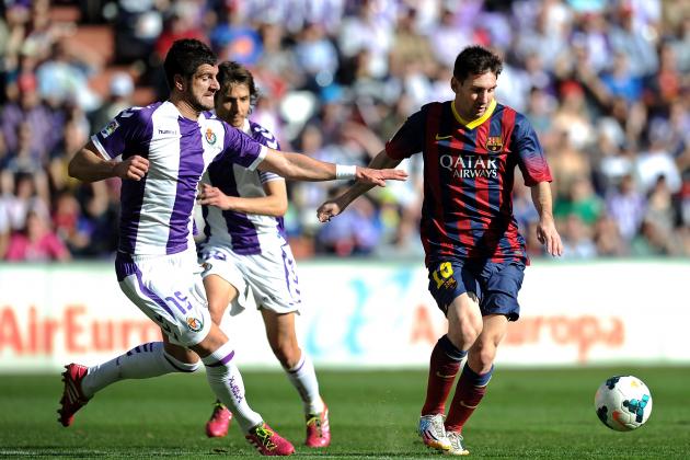 VALLADOLID, SPAIN - MARCH 08:  Lionel Messi (R) of FC Barcelona is tackled by Stefan Mitrovic of Valladolid CF during the La Liga match between Real Valladolid CF and FC Barcelona at estadio Nuevo Jose Zorillo on March 8, 2014 in Valladolid, Spain.  (Photo by Denis Doyle/Getty Images)