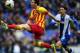 FC Barcelona's Lionel Messi, left, duels for the ball against Espanyol's Diego Colotto during a Spanish La Liga soccer match against Espanyol at Cornella-El Prat stadium in Cornella Llobregat, Spain, Saturday, March 29, 2014. (AP Photo/Manu Fernandez)