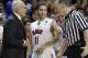 SMU guard Nic Moore (11) smiles as head coach Larry Brown listens to the referee during the second half of an NCAA college basketball game against Cincinnati Saturday, Feb. 8, 2014, in Dallas. SMU won 76-55. (AP Photo/LM Otero)