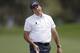 Phil Mickelson reacts as he misses an eagle putt on the 14th hole during the third round of the Texas Open golf tournament, Saturday, March 29, 2014, in San Antonio. Mickelson withdrew from the tournament with a pulled muscle. (AP Photo/Eric Gay)