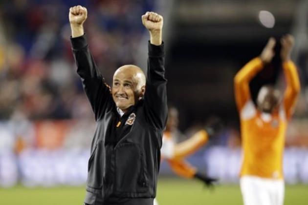 Houston Dynamo head coach Dominic Kinnear celebrates after his team beat the New York Red Bulls 2-1 in overtime during an MLS soccer playoff game Wednesday, Nov. 6, 2013, in Harrison, N.J. (AP Photo/Julio Cortez)