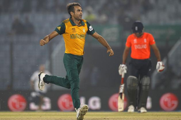 South Africa's Imran Tahir, left, celebrates taking the wicket of England's Jos Buttler during their ICC Twenty20 Cricket World Cup match in Chittagong, Bangladesh, Saturday, March 29, 2014. (AP Photo/A.M. Ahad)