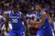 INDIANAPOLIS, IN - MARCH 30: Aaron Harrison #2 of the Kentucky Wildcats celebrates with teammate Julius Randle #30 after defeating the Michigan Wolverines 75 to 72 in the midwest regional final of the 2014 NCAA Men's Basketball Tournament at Lucas Oil Stadium on March 30, 2014 in Indianapolis, Indiana. (Photo by Jonathan Daniel/Getty Images)
