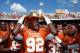 DALLAS, TX - OCTOBER 12: Reggie Wilson #92 of the Texas Longhorns celebrates with the game trophy after the Longhorns beat the Sooners 36-20 at the Cotton Bowl on October 12, 2013 in Dallas, Texas. (Photo by Tom Pennington/Getty Images)