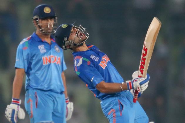 DHAKA, BANGLADESH - APRIL 04:  Virat Kohli of India screams after he hit the winning runs as MS Dhoni looks on as India win the ICC World Twenty20 Bangladesh 2014 2nd Semi-Final match between India and South Africa at Sher-e-Bangla Mirpur Stadium on April 4, 2014 in Dhaka, Bangladesh.  (Photo by Scott Barbour/Getty Images)