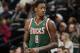 Milwaukee Bucks center Larry Sanders takes court against the Denver Nuggets in the fourth quarter of the Nuggets' 110-100 victory in an NBA basketball game in Denver on Wednesday, Feb. 5, 2014. (AP Photo/David Zalubowski)