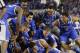 Kentucky players celebrate on the court after their 74-73 victory over Wisconsin in an NCAA Final Four tournament college basketball semifinal game Saturday, April 5, 2014, in Arlington, Texas. (AP Photo/Eric Gay)