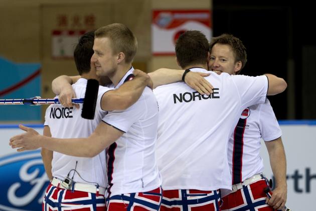 Norway's players from left, Thomas Ulsrud, Havard Vad Petersson, Christoffer Svae and Torger Nergard congratulate each other after they won the World Men's Curling Championship final match against Sweden at the Capital Gymnasium in Beijing, China Sunday, April 6, 2014. Norway defeated Sweden 8-3 in the final. (AP Photo/Andy Wong)