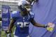 New York Giants running back Andre Brown holds a gift from Joe Vostal, of Summit, N.J., which was given to him for his birthday before an NFL football game against the Seattle Seahawks, Sunday, Dec. 15, 2013, in East Rutherford, N.J. Brown turned 27 on Sunday. (AP Photo/Julio Cortez)