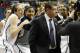 Connecticut's Breanna Stewart, left, and Kaleena Mosqueda-Lewis, center, sing Happy Birthday behind head coach Geno Auriemma, right, as he is interviewed on live television after their 87-44 win over Prairie View A&M in a first-round game of the NCAA women's college basketball tournament, Sunday, March 23, 2014, in Storrs, Conn. Today is Auriemma's 60th birthday. (AP Photo/Jessica Hill)
