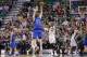 Dallas Mavericks' Dirk Nowitzki (41) shoots a 3-pointer as Utah Jazz's Jeremy Evans (40) defends in the fourth quarter of an NBA basketball game Tuesday, April 8, 2014, in Salt Lake City. The Mavericks won 95-83. (AP Photo/Rick Bowmer)