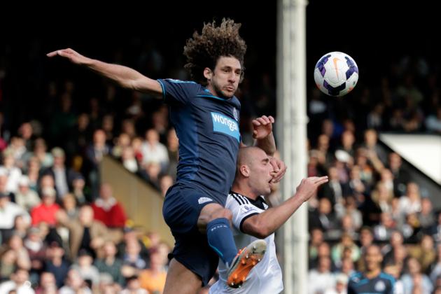 Fulham's Pajtim Kasami, right, competes for the ball with Newcastle United's Fabricio Coloccini during the English Premier League soccer match between Fulham and Newcastle United at Craven Cottage stadium in London, Saturday, March 15, 2014. (AP Photo/Matt Dunham)