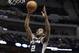 San Antonio Spurs forward Kawhi Leonard (2) drives to the basket past Dallas Mavericks guard Monta Ellis (11) during the first half an NBA basketball game Thursday, April 10, 2014, in Dallas. (AP Photo/LM Otero)