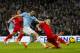 Manchester City's Alvaro Negredo, centre left, has a shot blocked by Liverpool's Martin Skrtel during their English Premier League soccer match at the Etihad Stadium, Manchester, England, Thursday Dec. 26, 2013. (AP Photo/Jon Super)