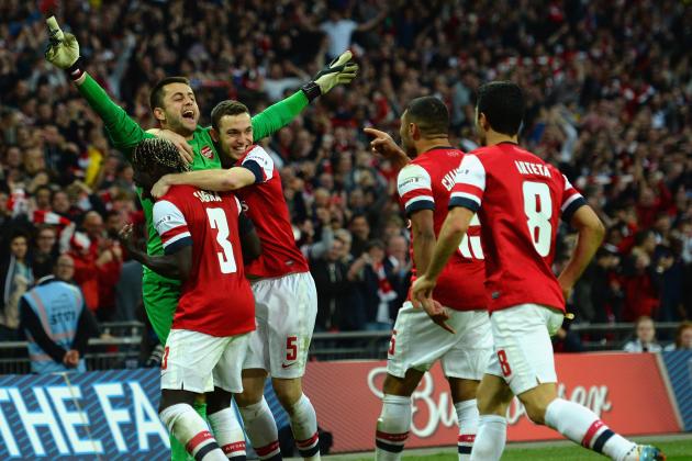 LONDON, ENGLAND - APRIL 12:  Lukasz Fabianski of Arsenal celebrates winning the penalty shoot out with team mates during the FA Cup Semi-Final match between Wigan Athletic and Arsenal at Wembley Stadium on April 12, 2014 in London, England.  (Photo by Shaun Botterill/Getty Images)