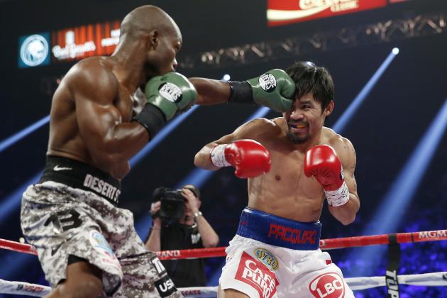 Timothy Bradley, left, lands a left to the head of Manny Pacquiao, of the Philippines, in their WBO welterweight title boxing fight Saturday, April 12, 2014, in Las Vegas. (AP Photo/Eric Jamison)