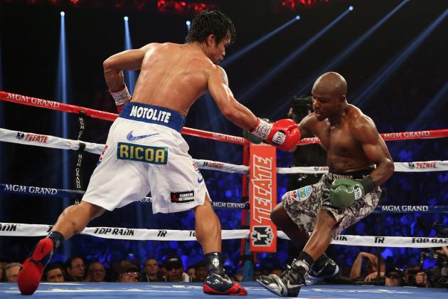 LAS VEGAS, NV - APRIL 12:  Manny Pacquiao catches Timothy Bradley off balance at the MGM Grand Garden Arena on April 12, 2014 in Las Vegas, Nevada.  (Photo by Jeff Gross/Getty Images)
