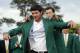 Defending Masters' champion Adam Scott, of Australia, helps Bubba Watson, left, with his green jacket after winning the Masters golf tournament Sunday, April 13, 2014, in Augusta, Ga. (AP Photo/David J. Phillip)