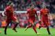 Liverpool's Philippe Coutinho centre, celebrates with team-mates Jon Flanagan right, and Steven Gerrard left, after he scores the third goal of the game for his side during their English Premier League soccer match against Manchester City at Anfield in Liverpool, England, Sunday April. 13, 2014. (AP Photo/Clint Hughes)