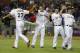 Miami Marlins starting pitcher Jose Fernandez, second from left, high fives right fielder Giancarlo Stanton (27) after the Marlins defeated the Cleveland Indians 10-0 in a baseball game, Friday, Aug. 2, 2013 in Miami. (AP Photo/Wilfredo Lee)