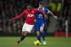 Manchester United's Patrice Evra, left, fights for the ball with Everton's Seamus Coleman during their English Premier League soccer match at Old Trafford Stadium, Manchester, England, Wednesday Dec. 4, 2013. (AP Photo/Jon Super)