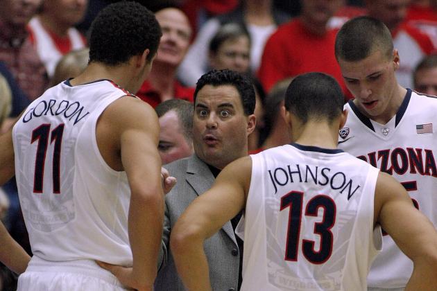 Arizona Head Coach Sean Miller, center, talks to Aaron Gordon (11) and Nick Johnson (13) during a timeout in the first half of an NCAA college basketball game against Utah on Sunday, Jan. 26, 2014, in Tucson, Ariz. (AP Photo/John Miller)