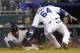 Cleveland Indians' Michael Bourn, left, gets back to first base before the tag of Kansas City Royals second baseman Emilio Bonifacio (64) during the fifth inning of a baseball game at Kauffman Stadium in Kansas City, Mo., Monday, Sept. 16, 2013. Bourn singled on a bunt to Royals third baseman Jamey Carroll who overthrew the first baseman on the play. (AP Photo/Orlin Wagner)