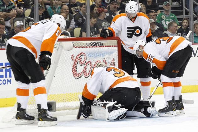 Apr 12, 2014; Pittsburgh, PA, USA; Philadelphia Flyers goalie Steve Mason (35) rest on the ice in front of Flyers defenseman Braydon Coburn (5) and defenseman Andrew MacDonald (47) and defenseman Mark Streit (32) against the Pittsburgh Penguins during the second period at the CONSOL Energy Center. The Flyers won 4-3 in overtime. Mandatory Credit: Charles LeClaire-USA TODAY Sports