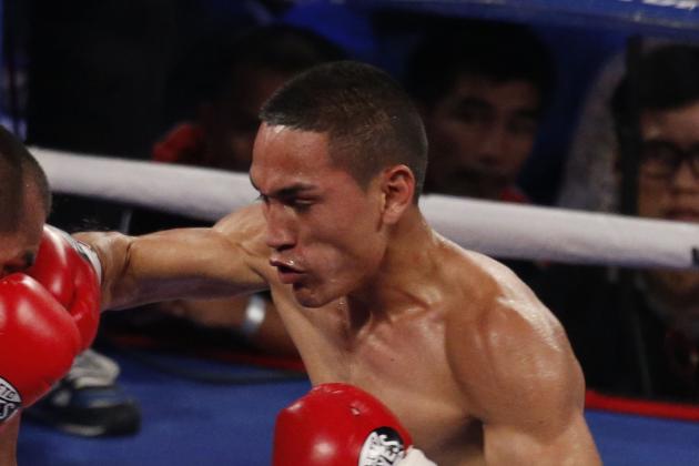 Mexico's Juan Francisco Estrada, right, fights against Milan Melindo of the Philippines during their WBO/WBA Flyweight Title match at the Cotai Arena in Venetian Macao in Macau Saturday July 27, 2013. (AP Photo/Dennis Ho)