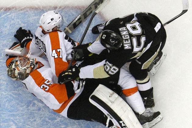 Pittsburgh Penguins' Jayson Megna (59) checks Philadelphia Flyers' Andrew MacDonald (47) into Flyers goalie Steve Mason (35) in the second period of an NHL hockey game in Pittsburgh, Saturday, April 12, 2014. Megna was penalized for goaltender interference. Mason was shaken up on the play, and did not return for the third period. The Flyers won 4-3 in overtime. (AP Photo/Gene J. Puskar)