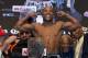 Floyd Mayweather Jr. poses for photos on the scale during the weigh-in for his Saturday boxing match against Canelo Alvarez, Friday, Sept. 13, 2013, in Las Vegas. (AP Photo/Julie Jacobson)