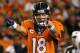 FILE - In this Sept. 5, 2013, file photo, Denver Broncos quarterback Peyton Manning (18) calls a play at the line of scrimmage during the first half of an NFL football game against the Baltimore Ravens in Denver. Manning is Sports Illustrated's Sportsman of the Year. He is the fourth NFL quarterback to take the honor in the last nine years, following Brady in 2005, Brett Favre in 2007 and Drew Brees in 2010. LeBron James was the winner last year. (AP Photo/Ed Andrieski, File)